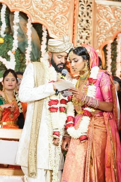 Indian couple reading their vows. Indian couple reading their vows.