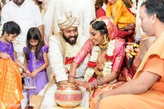 Indian couple putting hands inside of a jar. Indian couple putting hands inside of a jar.