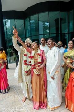 Maharani and her Indian groom pointing at the sky. Maharani and her Indian groom pointing at the sky.