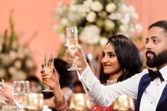 Indian couple making a toast during reception. Indian couple making a toast during reception.