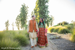 Indian bride and Indian groom walking while holding hands. Indian bride and Indian groom walking while holding hands.