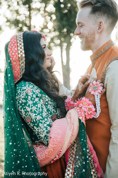 Maharani with a green Saree and her groom in orange nehru jacket. Maharani with a green Saree and her groom in orange nehru jacket.