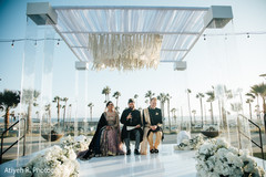 Indian bride and Indian groom sitting on their wedding altar. Indian bride and Indian groom sitting on their wedding altar.