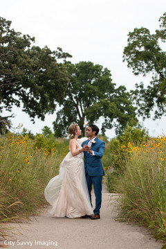 Indian couple dancing outdoors on their reception outfits. Indian couple dancing outdoors on their reception outfits.