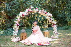 Overview of Maharani's baby pink-toned bridal saree and floral decor. Overview of Maharani's baby pink-toned bridal saree and floral decor.