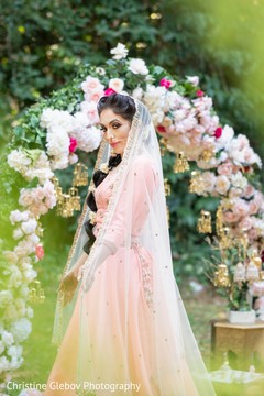 Maharani wearing the baby pink bridal ensemble posing for pictures. Maharani wearing the baby pink bridal ensemble posing for pictures.