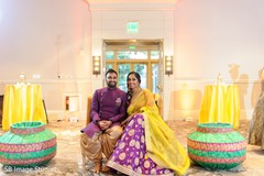 Indian couple posing at their Sangeet stage. Indian couple posing at their Sangeet stage.