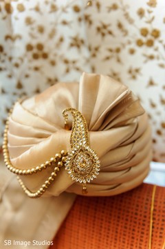 Golden indian groom's turban with jewelry on. Golden indian groom's turban with jewelry on.
