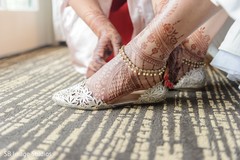 Indian bride getting her wedding shoes on. Indian bride getting her wedding shoes on.