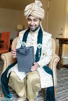 Indian groom on his ceremony outfit holding his present. Indian groom on his ceremony outfit holding his present.