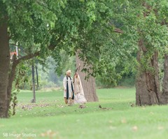 Indian Couple walking outdoors with their ceremony outfits. Indian Couple walking outdoors with their ceremony outfits.