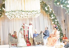 Indian groom putting the jaimala garland to bride ritual. Indian groom putting the jaimala garland to bride ritual.