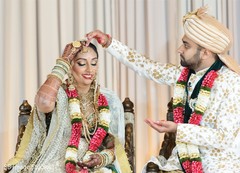 Indian groom putting the red mark on maharani's forehead. Indian groom putting the red mark on maharani's forehead.
