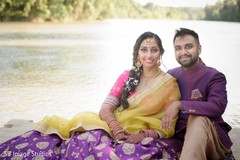 Indian bride and groom posing outdoors with sangeet outfits. Indian bride and groom posing outdoors with sangeet outfits.