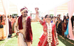 Indian couple raising hands coming out of the ceremony. Indian couple raising hands coming out of the ceremony.
