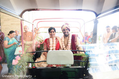 Indian couple in a golf cart decorated with flowers. Indian couple in a golf cart decorated with flowers.