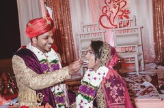 Indian bride and groom sharing a slice of cake during the reception. Indian bride and groom sharing a slice of cake during the reception.