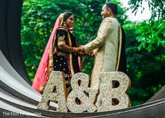 Indian bride and groom holding hands during pictures. Indian bride and groom holding hands during pictures.