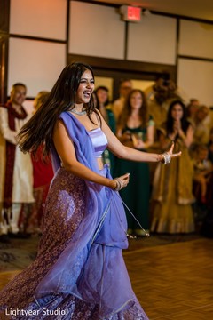 Indian bridesmaid dancing with her purple lehenga. Indian bridesmaid dancing with her purple lehenga.