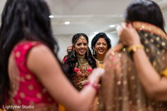 Indian bride getting her hair jewelry decoration on. Indian bride getting her hair jewelry decoration on.