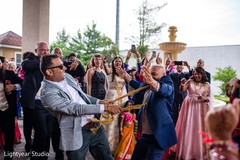 Indian groom running in circles with groomsmen. Indian groom running in circles with groomsmen.