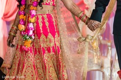 Indian bride and groom holding hands during the knot ritual. Indian bride and groom holding hands during the knot ritual.