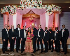 Indian couple posing with groomsmen capture. Indian couple posing with groomsmen capture.