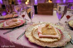 Indian wedding reception golden and pink dinner table set. Indian wedding reception golden and pink dinner table set.
