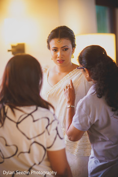 Indian bride getting ready and being assisted. Indian bride getting ready and being assisted.