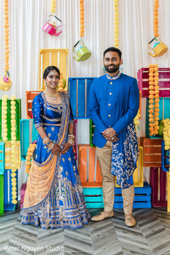Maharani and her Indian groom posing in front of some decorations Maharani and her Indian groom posing in front of some decorations
