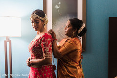 Indian relative helping Maharani with getting dressed. Indian relative helping Maharani with getting dressed.