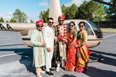 Indian groom and Indian relatives posing in front of the chopper Indian groom and Indian relatives posing in front of the chopper
