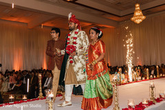 Indian groom walking down the aisle with his Indian relatives Indian groom walking down the aisle with his Indian relatives