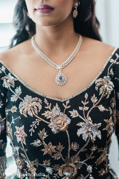 Maharani wearing a silver necklace with saphire and diamonds.