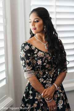 Maharani wearing a black gown with golden details. Maharani wearing a black gown with golden details.