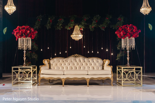 Stage decorated with chandeliers and flowers for photo session.