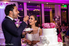 Indian bride and groom sharing a slice of cake. Indian bride and groom sharing a slice of cake.