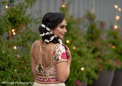 Indian bride with her pre-wedding hairstyle and lehenga. Indian bride with her pre-wedding hairstyle and lehenga.