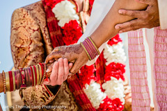 Indian bride holding her mother's hand during the ceremony. Indian bride holding her mother's hand during the ceremony.