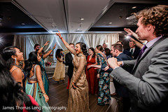 Indian bride and bridesmaids dancing at reception. Indian bride and bridesmaids dancing at reception.