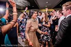 Indian bride celebrating with guests at reception . Indian bride celebrating with guests at reception .