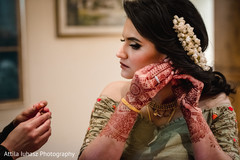 Indian bride putting earrings. Indian bride putting earrings.
