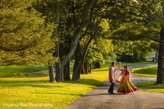 Indian bride and groom outdoors during pictures. Indian bride and groom outdoors during pictures.