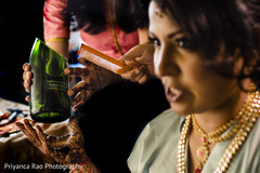 Indian bride being assisted by hair and makeup artist. Indian bride being assisted by hair and makeup artist.