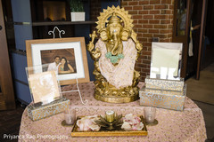 Statue of Ganesha with couple's pictures. Statue of Ganesha with couple's pictures.