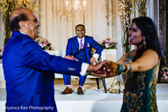 Indian bride and family dancing during the reception. Indian bride and family dancing during the reception.