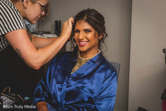 Maharani smiling at the camera while her make up is being done Maharani smiling at the camera while her make up is being done