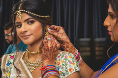 Indian relative helping the Indian bride with her jewelry Indian relative helping the Indian bride with her jewelry