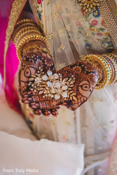 Indian bride showing a flower shaped brooch Indian bride showing a flower shaped brooch