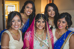 Indian bride posing with her Indian bridesmaids in her chambers Indian bride posing with her Indian bridesmaids in her chambers